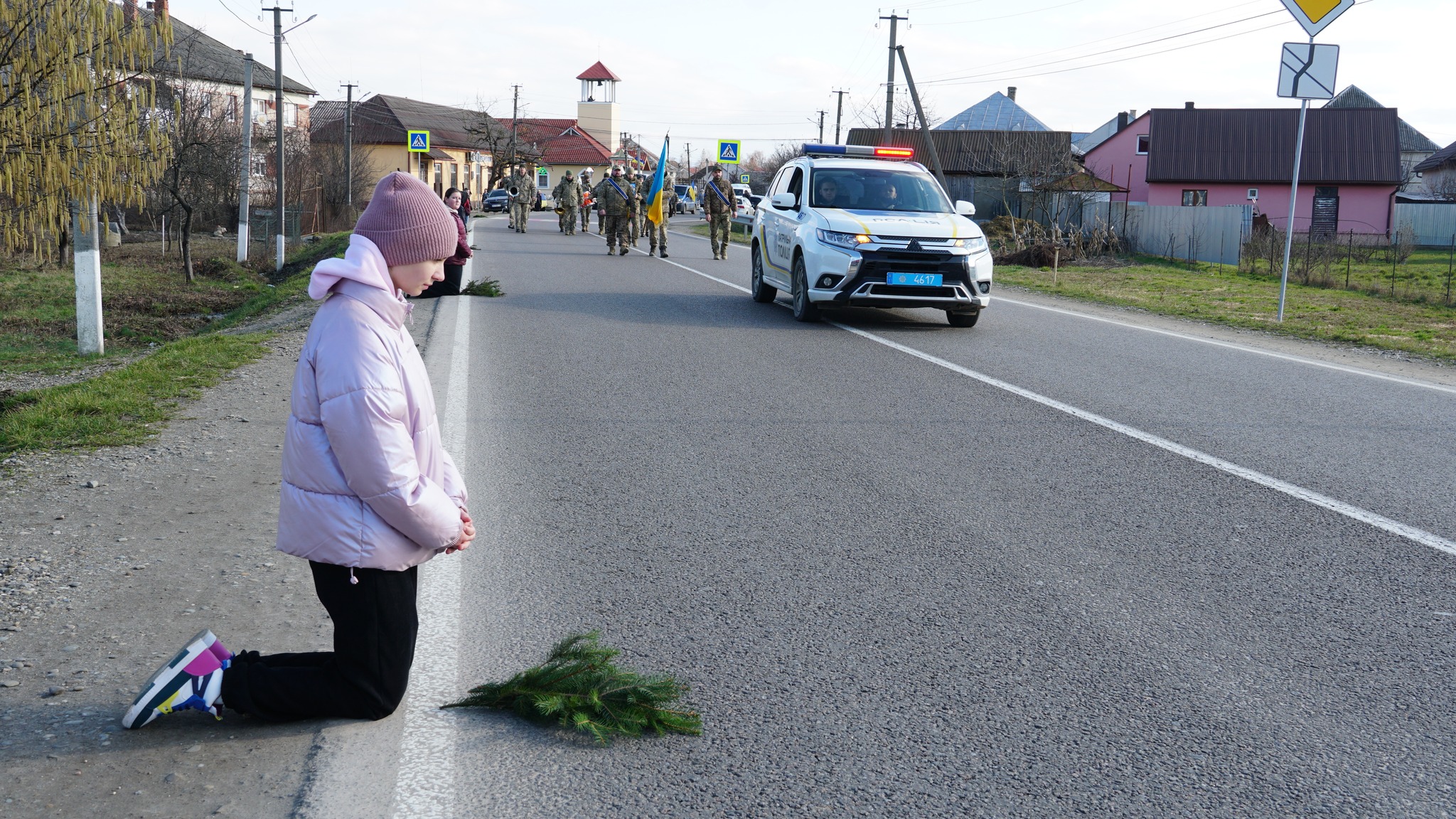 Юна землячка навколішки прощається з полеглим захисником-односельцем 