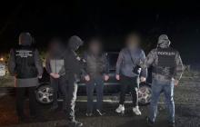 Затримані чоловіки й організатор